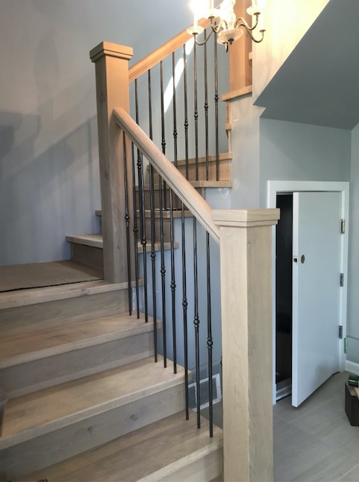 oak hardwood stairs with wrought iron balusters and newel posts